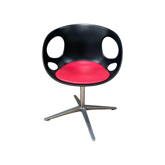 Red and black Fritz Hansen swivel dining chair.