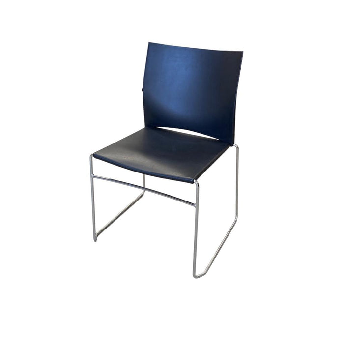 Xpresso black stacking chair with metal legs, from the side. 