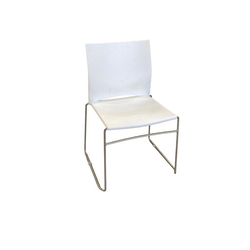 White Xpresso stacking chair with metal legs, from the side.