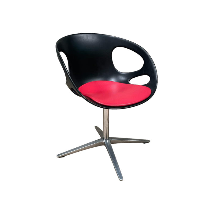 Red and black Fritz Hansen swivel dining chair.