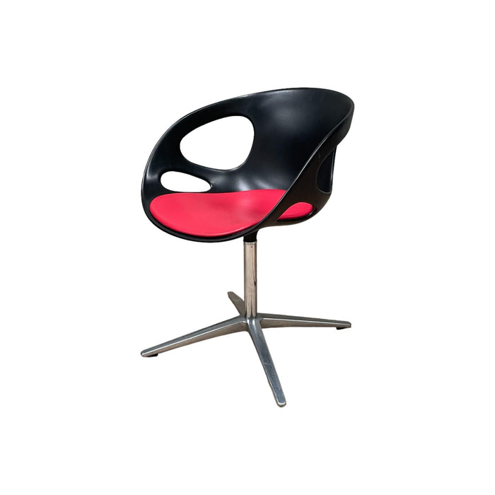 Red and black Fritz Hansen swivel dining chair.