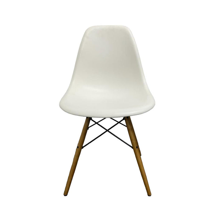 White Vitra DSW eames chair with wooden legs.