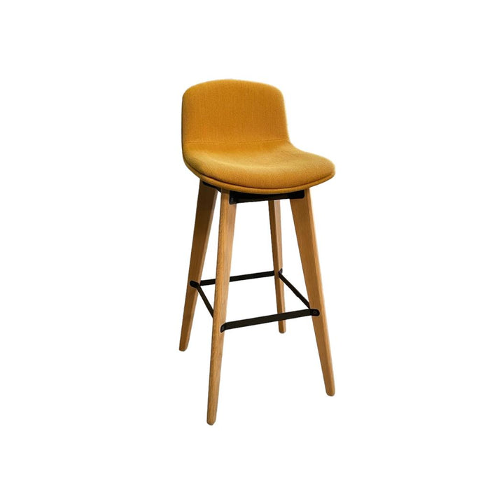 Upholstered yellow bar stools with wooden legs and footrest from the side.