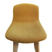Close up of upholstered yellow bar stools with wooden legs.