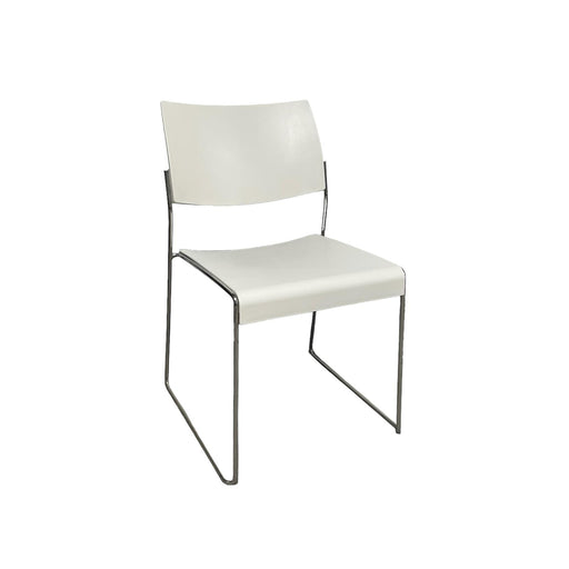 White lino stacking chair with metal legs, from side.