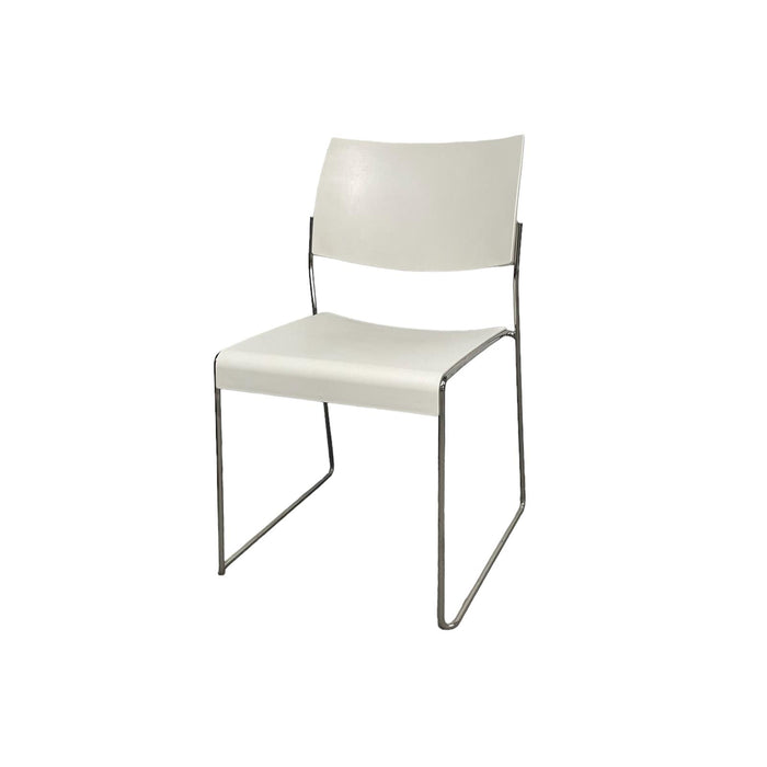 White lino stacking chair with metal legs, from side.