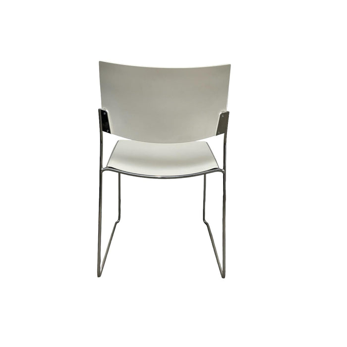White lino stacking chair with metal legs, from back.