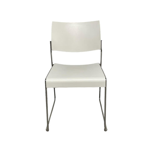 White lino stacking chair with metal legs, from front.